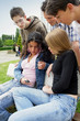 Teens gathered on park bench