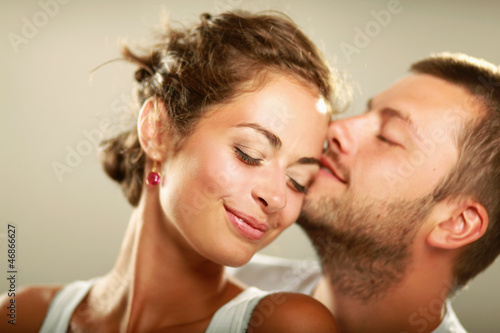 Photo: Young man and woman together over white background Young man and woman together over white background