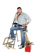 Carpenter stood by equipment making call