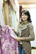 woman  chooses draperies