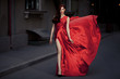 Young Beauty Famous Woman In Fluttering Red Dress Outdoor