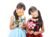Two little asian girls wearing dress