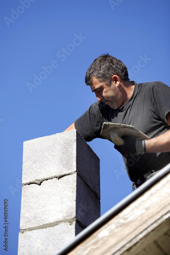 Photo: Mason building chimney Mason building chimney