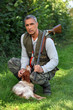 Hunter with shotgun and spaniel
