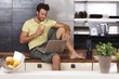 Young man with laptop and sandwich