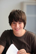 Teenage boy turning a page