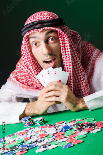 Photo: Arab playing in casino - gambling concept with man Arab playing in casino - gambling concept with man