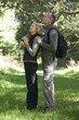 A mature couple, woman holding a pair of binoculars