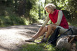 A woman hiker massaging her sore feet