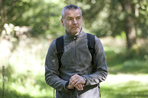 Photo: A portrait of a mature man standing in the countryside A portrait of a mature man standing in the countryside