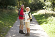 Photo: A mature couple standing on a country path, smiling A mature couple standing on a country path, smiling