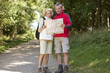 A mature couple walking in the countryside looking at a map