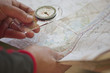 A man holding a map and compass, close up