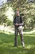 A portrait of a mature man standing in the countryside