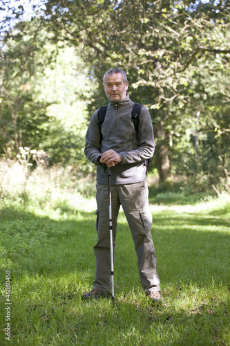 Photo: A portrait of a mature man standing in the countryside A portrait of a mature man standing in the countryside