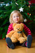 Foto: little girl in front of christmastree little girl in front of christmastree