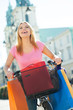 Woman on bike with shopping bags