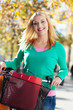 Woman outdoors on bicycle with shopping bags
