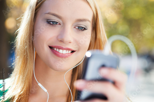 Photo: Young woman with music player Young woman with music player