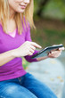 Woman using digital tablet outdoors