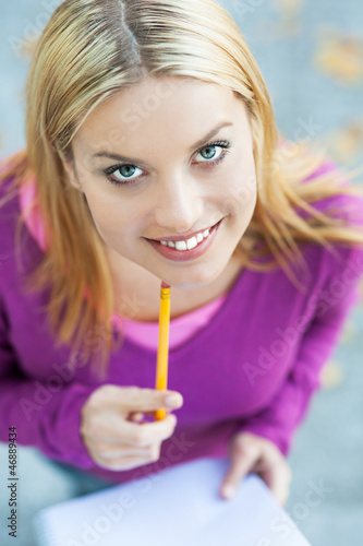 Photo: Student with notebook and pencil Student with notebook and pencil