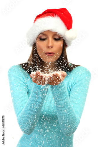 Photo: beautiful young woman blowing snow, isolated on white beautiful young woman blowing snow, isolated on white