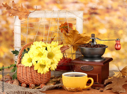 Photo: autumnal composition:coffee grinder, flowers and leaves autumnal composition:coffee grinder, flowers and leaves
