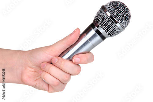 Photo: Silver microphone in hand isolated on white Silver microphone in hand isolated on white
