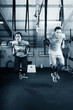 Young gymnasts training on rings on a dark background
