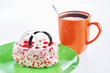 Cup of coffee and sweet cake on a green plate for breakfast