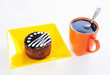 Round chocolate cake with cup of coffee