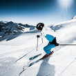 Skier in mountains, prepared piste and sunny day