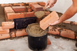 Starting to build a stove - closeup on hands