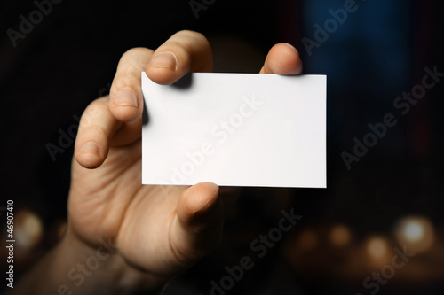 Photo: Man holding business card. Close up shot Man holding business card. Close up shot