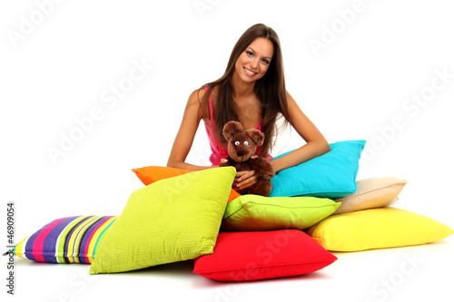 Photo: beautiful young girl and fluffy bear with pillows isolated beautiful young girl and fluffy bear with pillows isolated