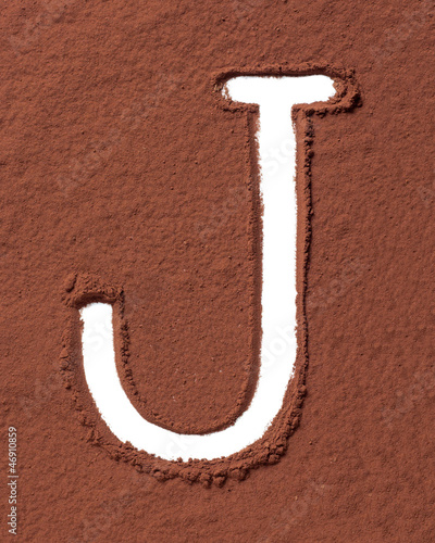 Photo: Letter J made of cocoa powder Letter J made of cocoa powder