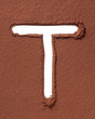 Letter T made of cocoa powder