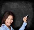 Teacher teaching writing on blackboard