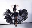 Photo: Fantastic fashion woman in fluttering black transparent dress Fantastic fashion woman in fluttering black transparent dress