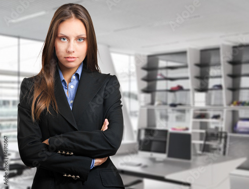 Photo: Businesswoman standing in her office Businesswoman standing in her office
