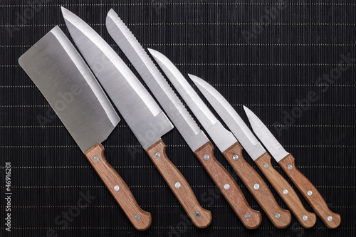 Photo: set of kitchen knifes on black mat set of kitchen knifes on black mat