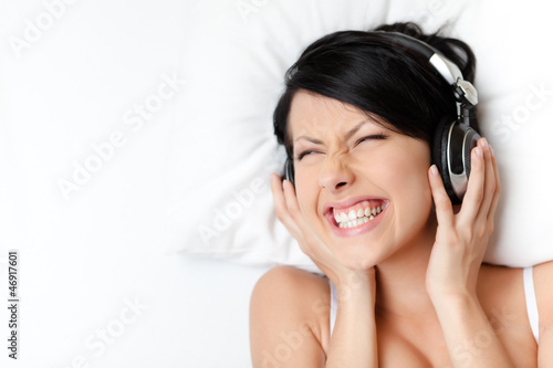Photo: Woman in underwear listens to music Woman in underwear listens to music