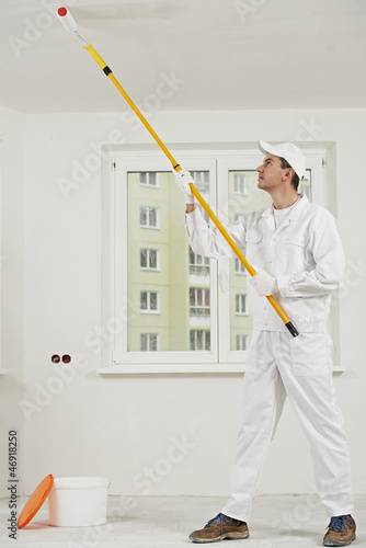 Photo: house painter at work with painting roller house painter at work with painting roller