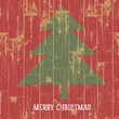 Christmas tree symbol and greetings on wooden planks texture. Ve