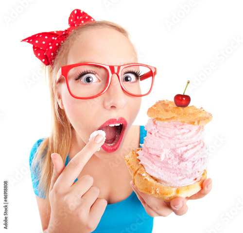 Photo: Funny girl eating a cream puff Funny girl eating a cream puff