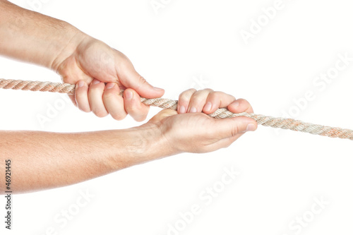 Photo: Man pulls something rope with both hands. On a white background. Man pulls something rope with both hands. On a white background.