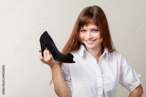 Photo: A beautiful woman with a shoe A beautiful woman with a shoe