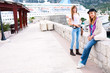 Happy tourist womans on a stone pier