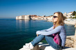 Woman sitting on pier on Adriatic sea, Europe