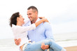 Happy young couple enjoying a solitary beach